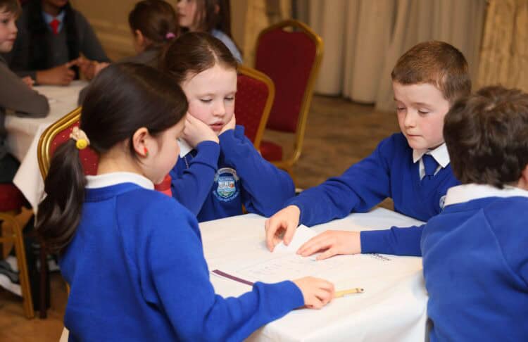 Image of four children sitting down at Claddagh Credit Union school quiz.